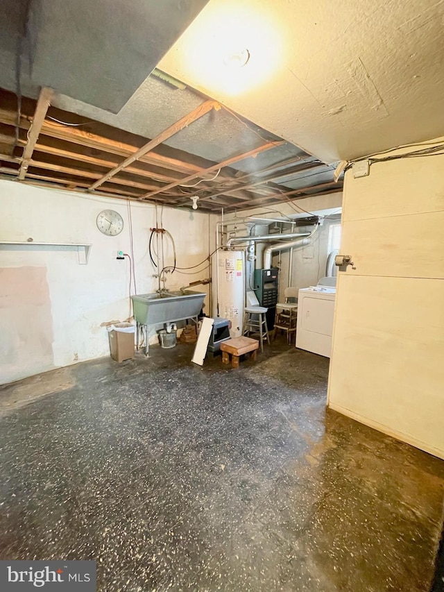 unfinished below grade area with washer / clothes dryer, water heater, and a sink