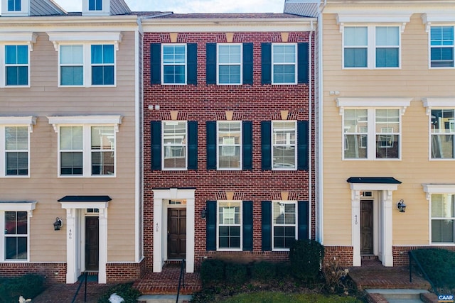 view of property featuring brick siding