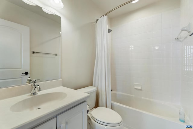 full bathroom with vanity, shower / bath combo with shower curtain, and toilet