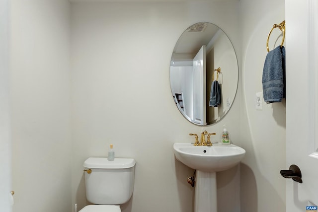 bathroom featuring toilet and a sink