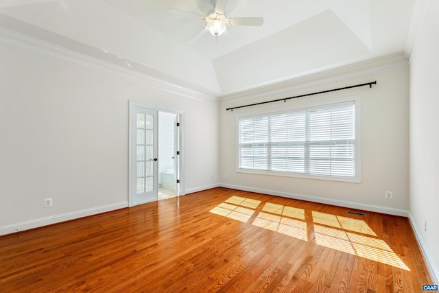 spare room featuring visible vents, crown molding, baseboards, and wood finished floors