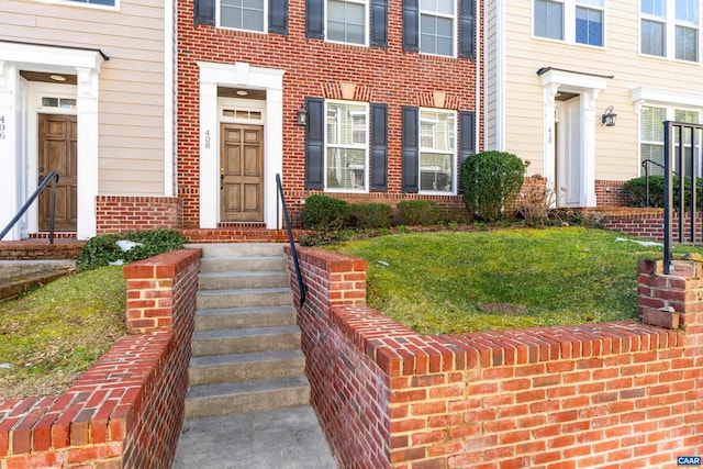 entrance to property featuring brick siding