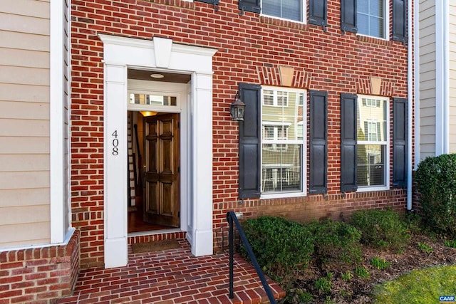 property entrance featuring brick siding