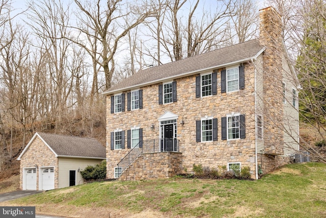 53 S Main St, Stockton, NJ 08559 - colonial house with aphalt driveway, an outbuilding, a chimney, and a front yard