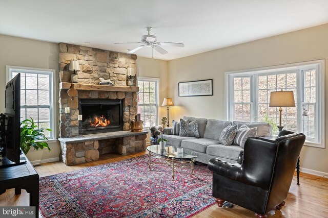 53 S Main St, Stockton, NJ 08559 - living area featuring baseboards, ceiling fan, wood finished floors, and a stone fireplace