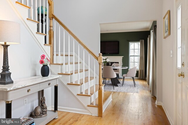 53 S Main St, Stockton, NJ 08559 - foyer with baseboards, stairs, a fireplace, and wood finished floors