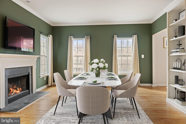 53 S Main St, Stockton, NJ 08559 - dining area with a warm lit fireplace, light wood-type flooring, ornamental molding, and baseboards