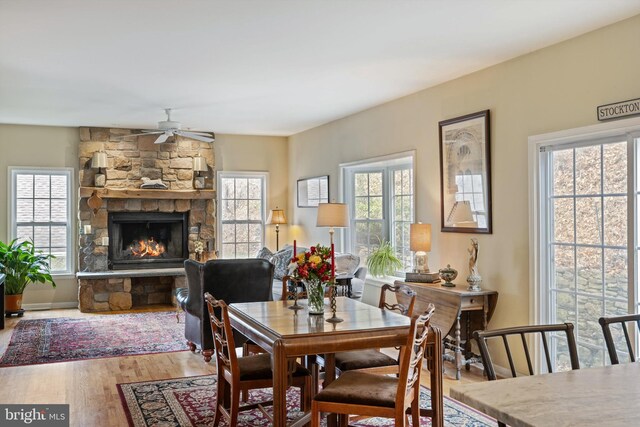 53 S Main St, Stockton, NJ 08559 - dining room with baseboards, a fireplace, wood finished floors, and ceiling fan