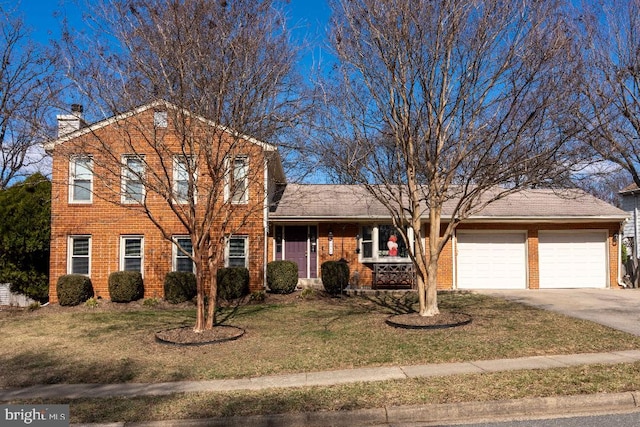 view of front of house featuring brick siding, a chimney, an attached garage, driveway, and a front lawn