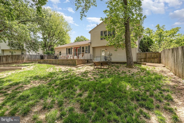 rear view of house with a wooden deck