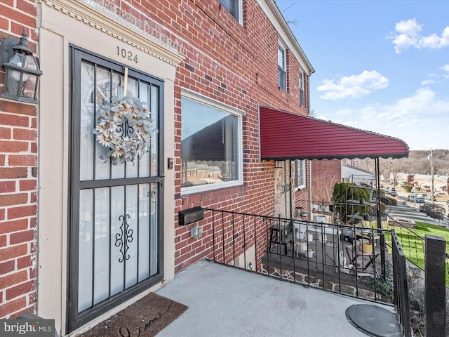 entrance to property with brick siding