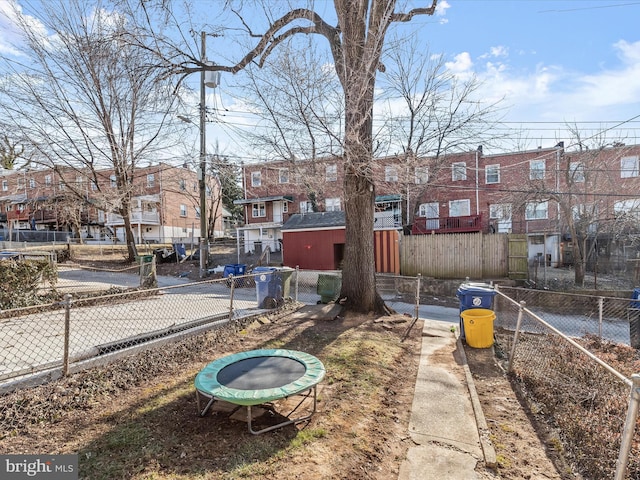 view of yard featuring a residential view and fence