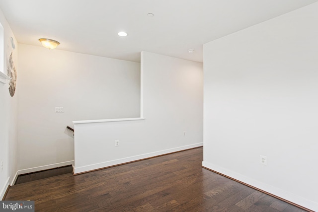 unfurnished room with baseboards, wood finished floors, and recessed lighting