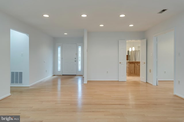 entryway featuring light wood-style floors, recessed lighting, and visible vents