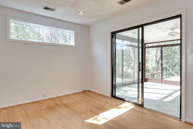 interior space with light wood-type flooring, baseboards, visible vents, and a ceiling fan