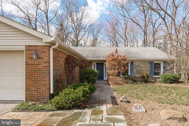 view of front of house featuring brick siding and an attached garage