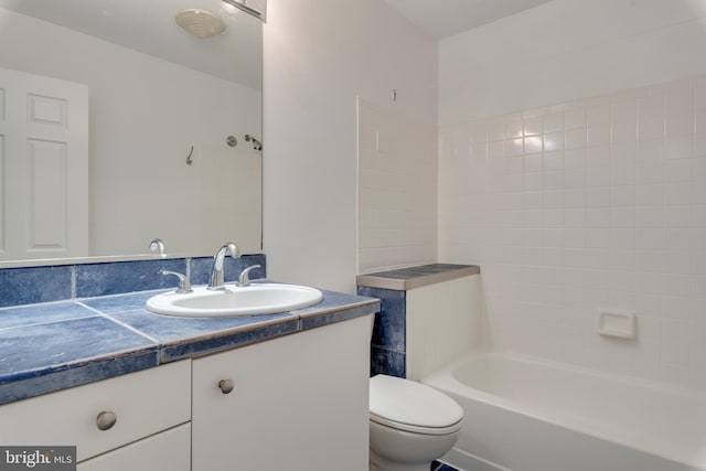 full bath with tub / shower combination, vanity, and toilet