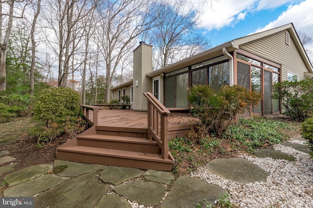 wooden deck featuring a sunroom