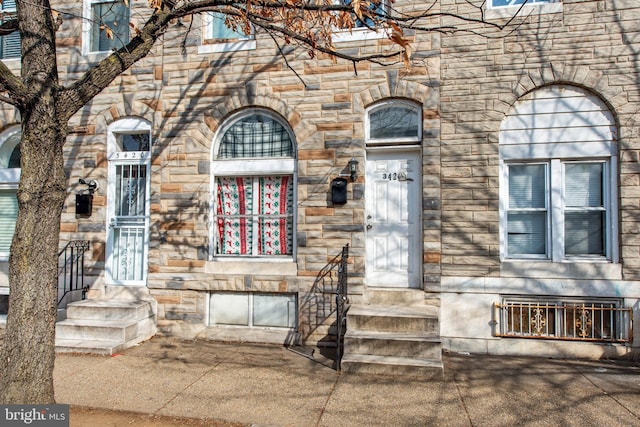 entrance to property with stone siding