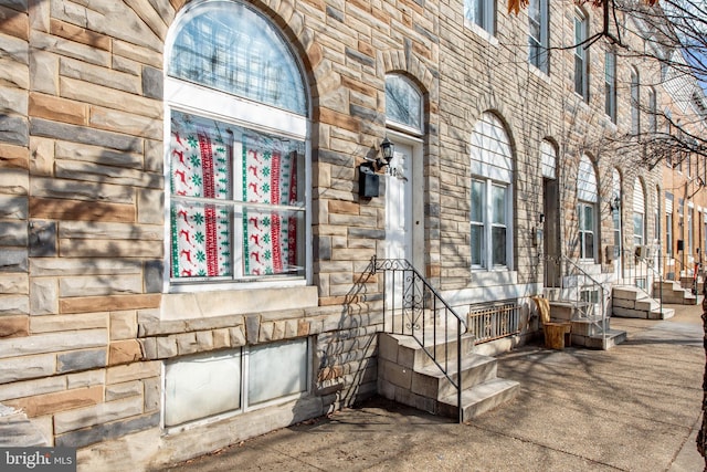 view of exterior entry featuring stone siding