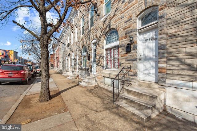 doorway to property featuring stone siding