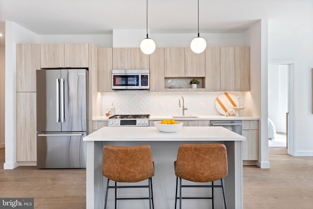 kitchen with stainless steel appliances, modern cabinets, and a kitchen breakfast bar