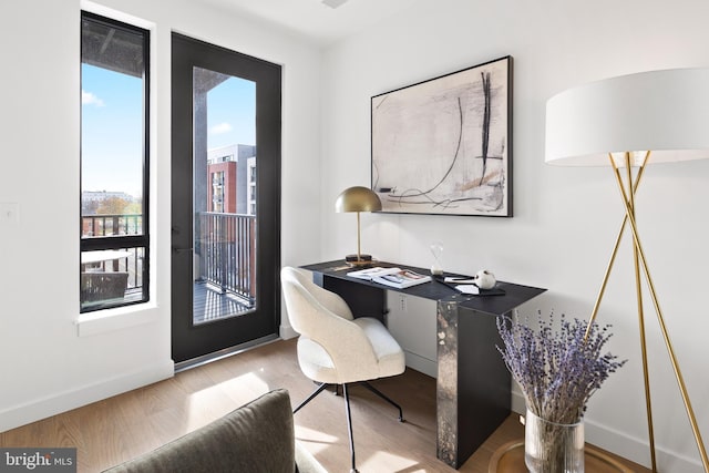 office featuring baseboards and wood finished floors