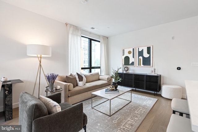 living room with visible vents and wood finished floors