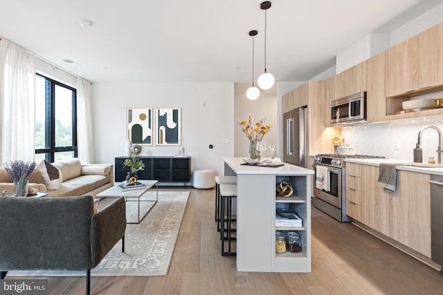 kitchen featuring modern cabinets, light brown cabinets, appliances with stainless steel finishes, and open shelves