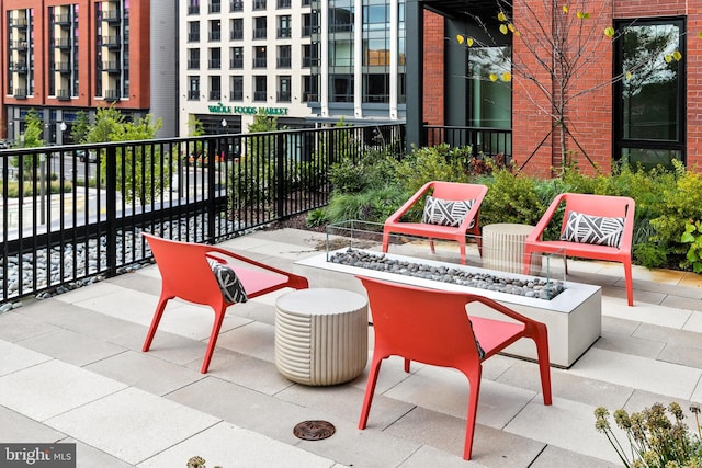 view of patio / terrace featuring an outdoor fire pit and fence