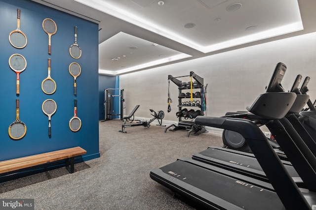 gym with a raised ceiling