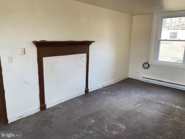 unfurnished room with baseboards, a baseboard heating unit, and concrete flooring