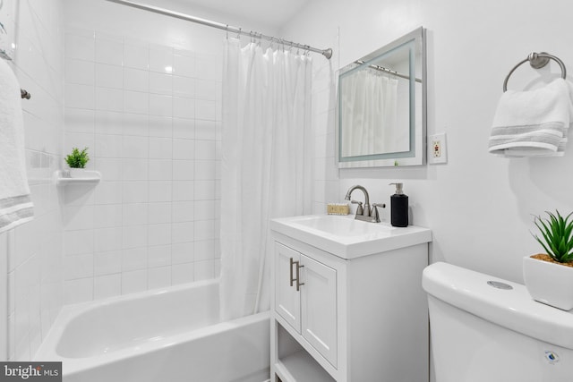 bathroom with shower / bath combo, vanity, and toilet