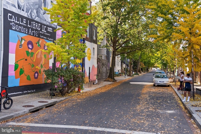 view of road with sidewalks and curbs