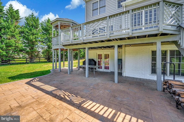 view of patio featuring a deck, french doors, and fence