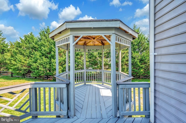 wooden terrace featuring a yard