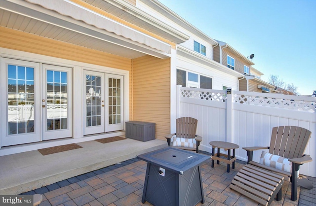 view of patio / terrace featuring french doors and fence