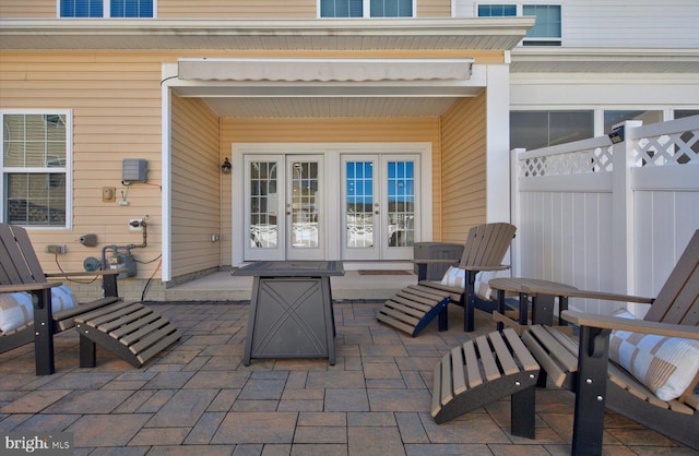 view of patio / terrace featuring fence and french doors