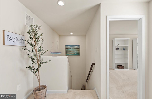 hall with visible vents, carpet, an upstairs landing, and recessed lighting