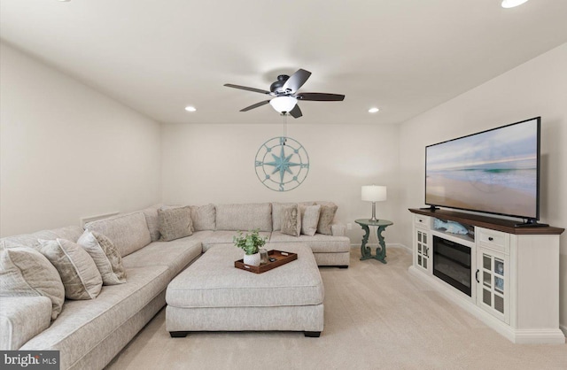 living room featuring light carpet, baseboards, a ceiling fan, and recessed lighting