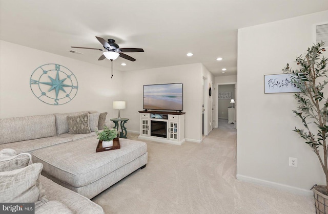 living area with visible vents, baseboards, a ceiling fan, light colored carpet, and recessed lighting