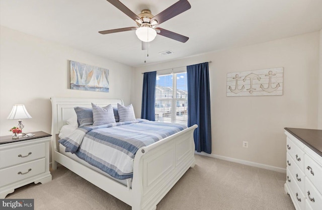 bedroom featuring light colored carpet, visible vents, ceiling fan, and baseboards