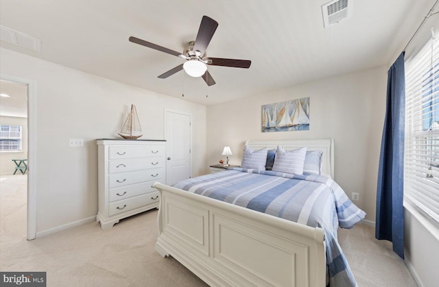 bedroom featuring light carpet, visible vents, and baseboards