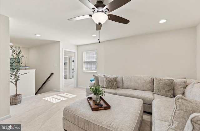 living room with baseboards, recessed lighting, and light colored carpet