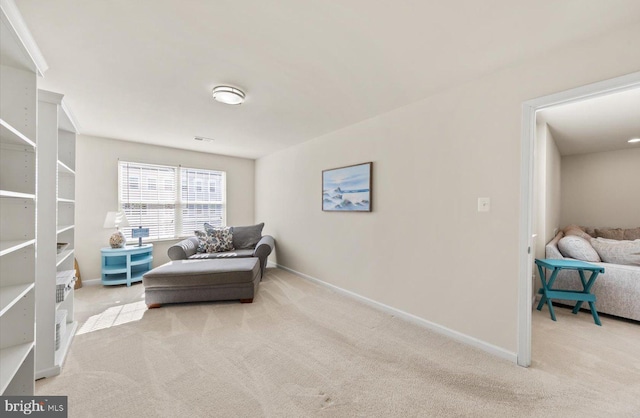 living area with carpet flooring, visible vents, and baseboards