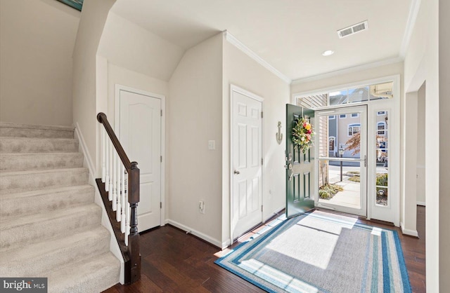 entrance foyer with crown molding, visible vents, wood finished floors, baseboards, and stairs