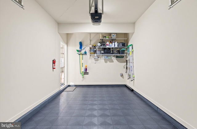 garage featuring baseboards and a garage door opener