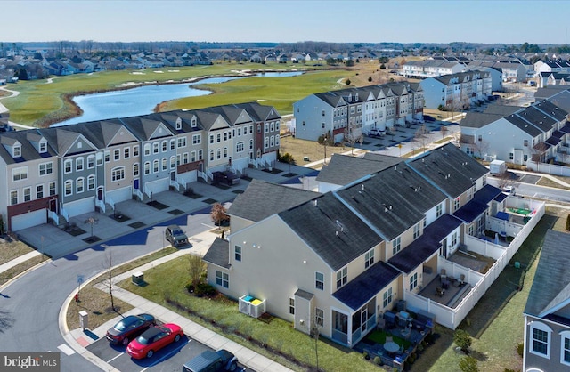 birds eye view of property featuring view of golf course, a water view, and a residential view