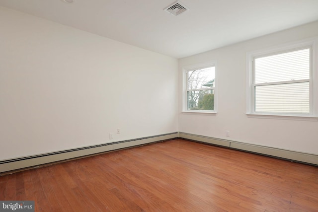 empty room featuring light wood-style flooring and visible vents