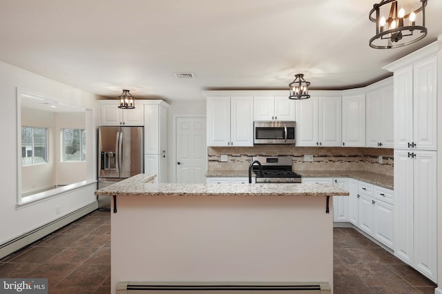 kitchen with stainless steel appliances, a baseboard radiator, visible vents, decorative backsplash, and white cabinets